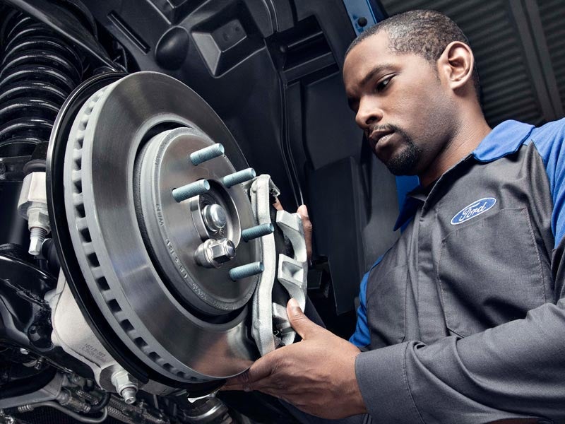 Ford mechanic doing brake repair