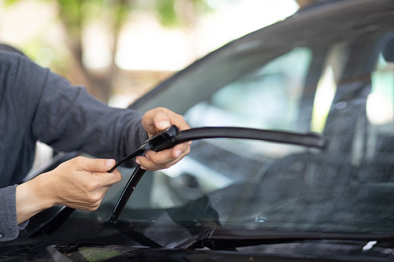 mechanic installing wiper blades